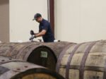 A man working on wine barrels in a Naples winery